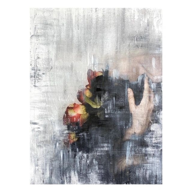 Hand holding glowing flowers against textured background
